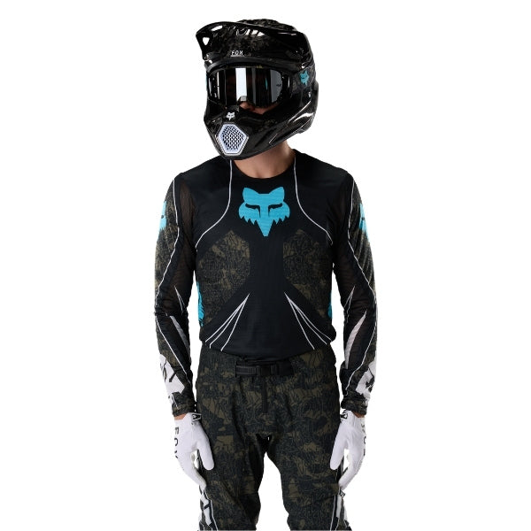 Fox Racing Flexair Apex Jersey in Black, close-up of the sleeve graphic and cuff, with the printed Fox artwork, mesh-knit texture, reinforced seam lines, and shaped cuff or hem. Available options—Color: Black; Size: SM, MD, LG, XL, 2X. SKU 40660-001-2X. UPC 198571133569.