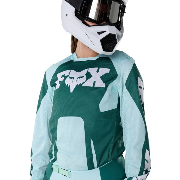 Fox Racing 180 Raid Jersey (Womens) in Melon, close-up of the chest and shoulder panels, with the printed Fox artwork, mesh-knit texture, reinforced seam lines, and shaped cuff or hem. Available options—Color: Lavender Drift, Melon; Size: XS, SM, MD, LG, XL. SKU 40669-413-L. UPC 198571127506.