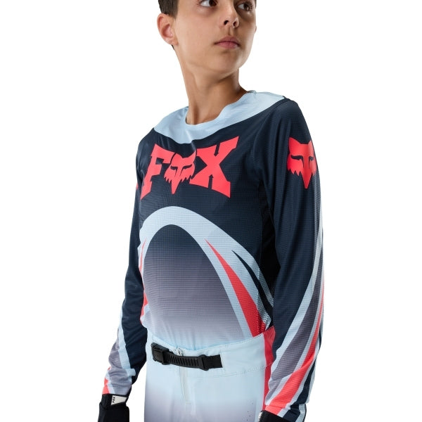Fox Racing Flexair Arc Jersey (Youth) in Ice Blue, modeled front three-quarter view, with the crew neck, long sleeves, contrasting shoulder and arm graphics, and extended rear hem on a rider. Available options—Color: Ice Blue, Chili; Size: Y-SM, Y-MD, Y-LG, Y-XL. SKU 40671-231-YL. UPC 198571126578.