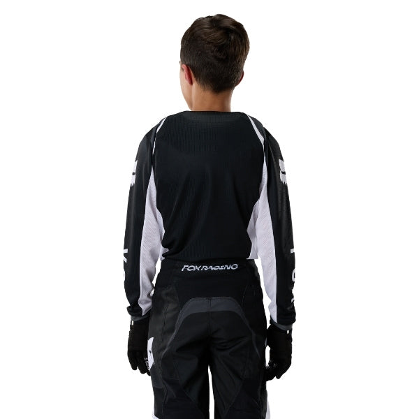 Fox Racing 180 Frame Jersey (Youth) in Red, modeled front three-quarter view, with the crew neck, long sleeves, contrasting shoulder and arm graphics, and extended rear hem on a rider. Available options—Color: Blue, Grey/Yellow, Black, Red; Size: Y-SM, Y-MD, Y-LG, Y-XL. SKU 40672-003-YL. UPC 198571130001.