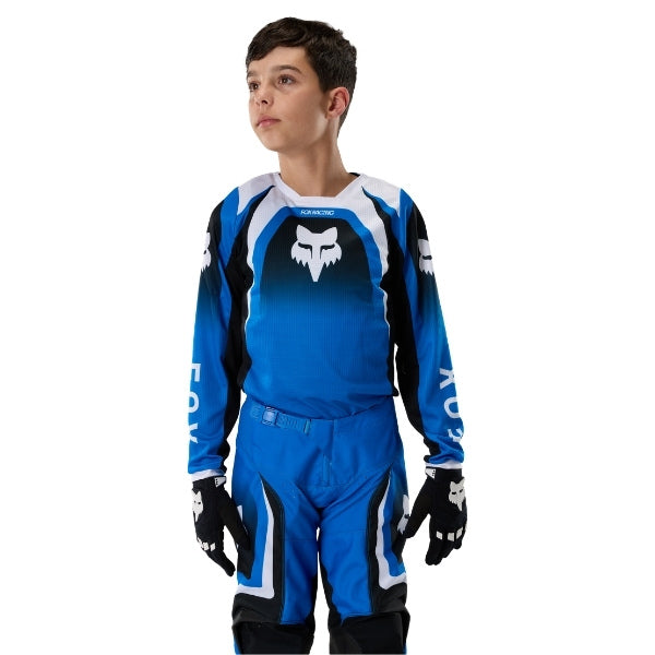 Fox Racing 180 Frame Jersey (Youth) in Blue, close-up of the chest and shoulder panels, with the printed Fox artwork, mesh-knit texture, reinforced seam lines, and shaped cuff or hem. Available options—Color: Blue, Grey/Yellow, Black, Red; Size: Y-SM, Y-MD, Y-LG, Y-XL. SKU 40672-002-YXL. UPC 198571124109.