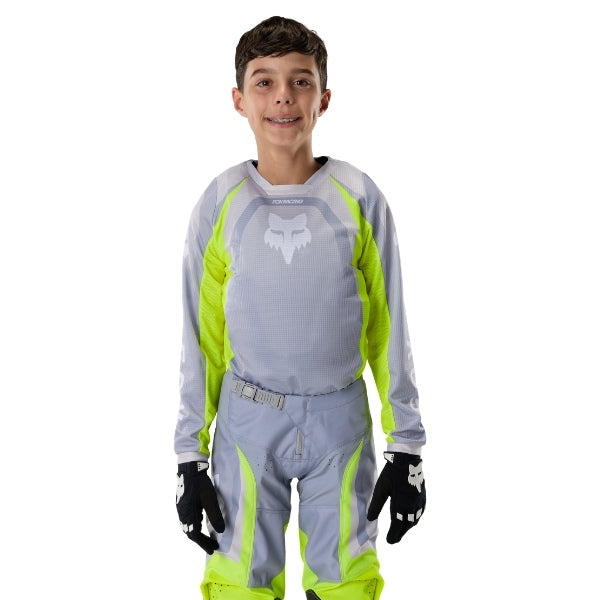 Fox Racing 180 Frame Jersey (Youth) in Black, front product view, with the crew neck, long sleeves, large Fox chest graphic, contrasting arm panels, and curved drop-tail hem. Available options—Color: Blue, Grey/Yellow, Black, Red; Size: Y-SM, Y-MD, Y-LG, Y-XL. SKU 40672-001-YS. UPC 198571122617.