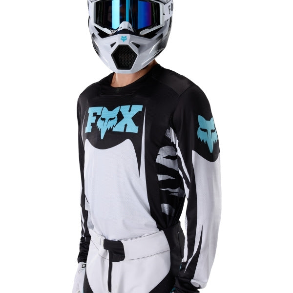 Fox Racing 360 Clutch Jersey in White/Black, modeled front three-quarter view, with the crew neck, long sleeves, contrasting shoulder and arm graphics, and extended rear hem on a rider. Available options—Color: White/Black, Neon Pink; Size: SM, MD, LG, XL, 2X. SKU 40678-058-L. UPC 198571132517.