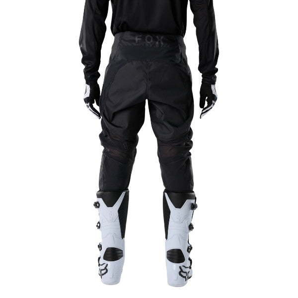 Fox Racing 180 Blackout Pants in Black, rear lower-leg and cuff view, with the reinforced seat, rear yoke, articulated knees, tapered legs, and lower-leg graphics. Available options—Color: Black; Size: 26, 28, 30, 32, 34, 36, 38, 40, 42, 44. SKU 40693-001-36. UPC 198571121979.