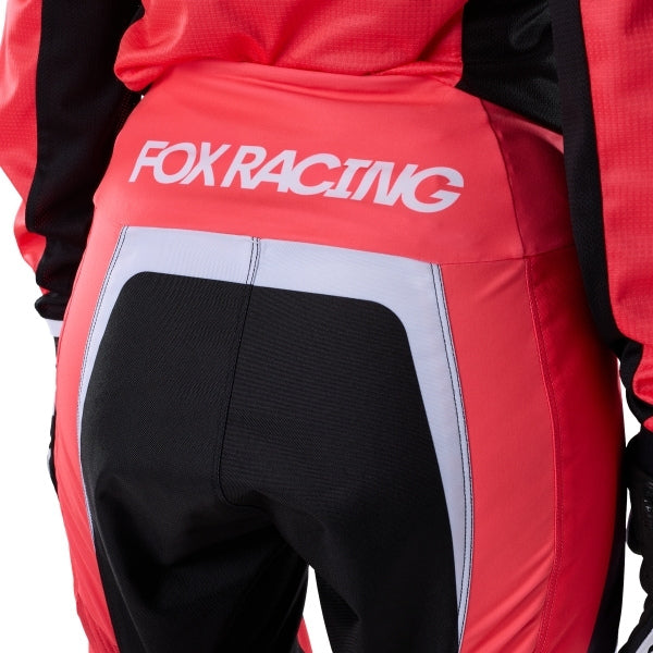 Fox Racing 180 Frame Pants (Womens) in Neon Pink, close-up of the ratcheting waist closure, with the ratcheting waist adjuster, stretch yoke, shaped hip panel, and reinforced knee or thigh material. Available options—Color: Neon Pink, Deep Blue; Size: 2, 4, 6, 8, 10, 12, 14, 16. SKU 40699-065-8. UPC 198571128176.