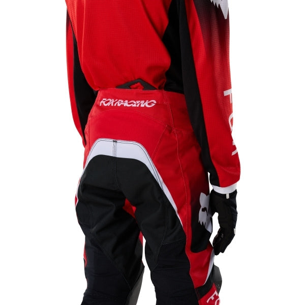 Fox Racing 180 Frame Pants (Youth) in Red, rear product view, with the reinforced seat, rear yoke, articulated knees, tapered legs, and lower-leg graphics. Available options—Color: Blue, Grey/Yellow, Black, Red; Size: Y-22, Y-24, Y-26, Y-28.