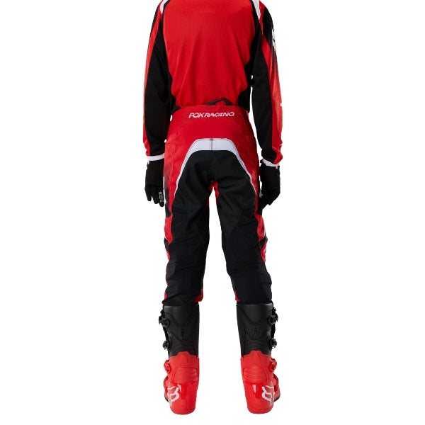 Fox Racing 180 Frame Pants (Youth) in Red, close-up of the ratcheting waist closure, with the ratcheting waist adjuster, stretch yoke, shaped hip panel, and reinforced knee or thigh material. Available options—Color: Blue, Grey/Yellow, Black, Red; Size: Y-22, Y-24, Y-26, Y-28. - alternate view