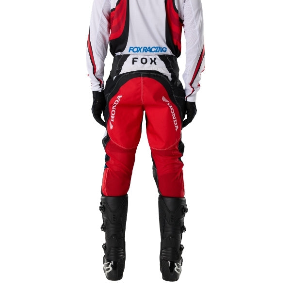Fox Racing 180 Honda Pants in White/Red, rear lower-leg and cuff view, with the reinforced seat, rear yoke, articulated knees, tapered legs, and lower-leg graphics. Available options—Color: White/Red; Size: 26, 28, 30, 32, 34, 36, 38. SKU 40708-077-36. UPC 198571132821. - alternate view