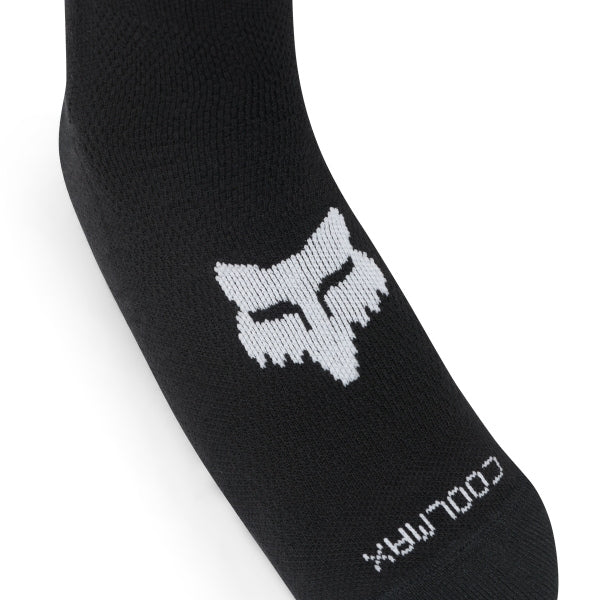Fox Racing Flexair Knee Brace Socks in Blue, close-up of the upper Fox logo panel, with the ribbed cuff, knitted Fox graphics, shaped heel, reinforced toe, and ventilated stretch knit. Available options—Color: Black, Blue, Red, Grey; Size: MD, LG. SKU 40714-002-L. UPC 198571124062.