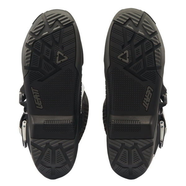 Leatt Moto 5.5 FlexLock Enduro Evo boots in Black/White, bottom view showing the tread pattern on both soles