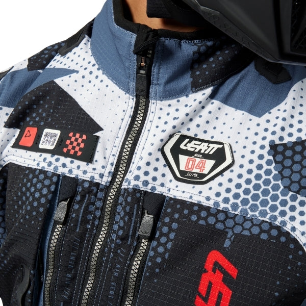 Leatt Moto 5.5 Enduro Jacket in Camo Grey, worn by a rider, showing the fit and front storage pockets