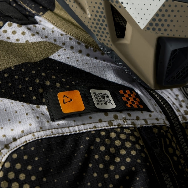 Leatt Moto 5.5 Enduro Jacket in Camo Khaki Brown, worn by a rider, showing the fit and front storage pockets