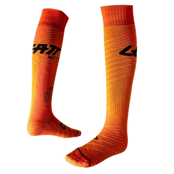 Leatt Moto socks in Hatchet Orange, pair shown from front and side, displaying the knee-high construction and graphics