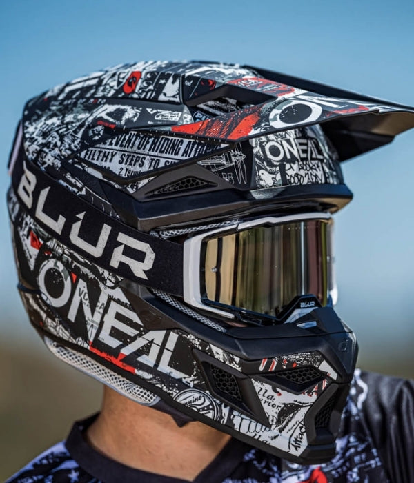 Motocross helmet with 'Oneal' and 'Blur' branding against a blurred outdoor background collection