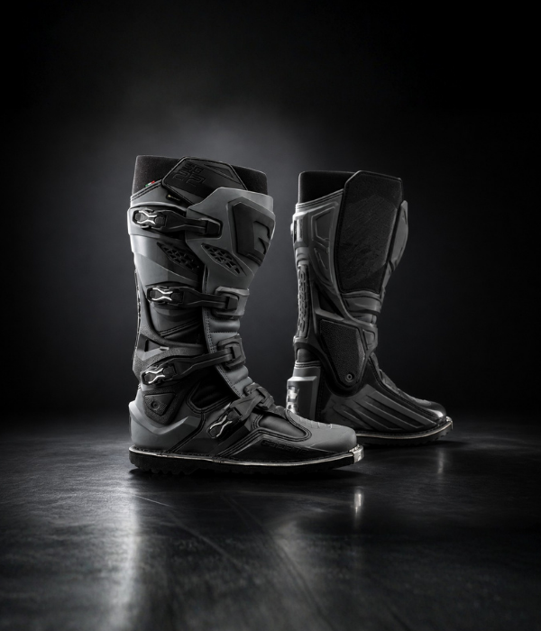 All-black Gaerne Gore-Tex motocross boots in a moody studio setting with reflective floor collection