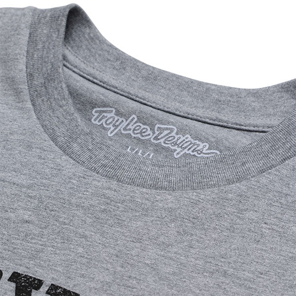 Professional studio photo of Troy Lee Designs Scholar Tee; showing tee fit, printed graphics, and crew neckline; SKU 7017650; Sizes: S-2XL