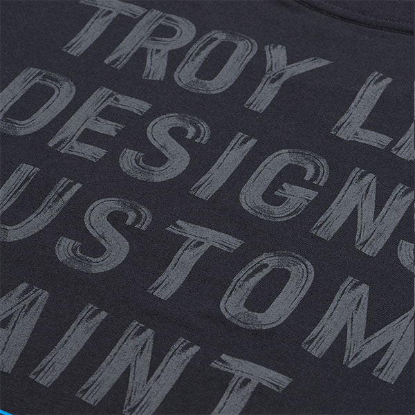 Clean studio shot of Troy Lee Designs Paint Shop Tee; showing tee fit, printed graphics, and crew neckline; SKU 7017290; Colors: Carbon, White