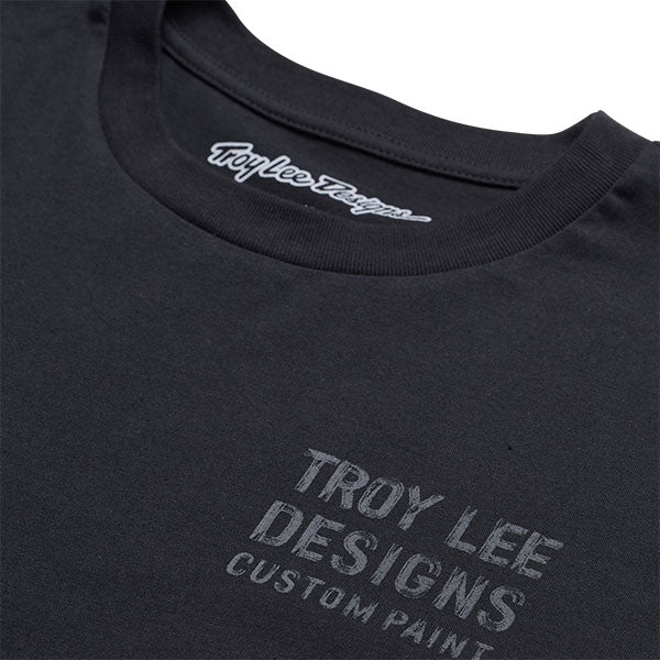 Professional studio photo of Troy Lee Designs Paint Shop Tee; showing tee fit, printed graphics, and crew neckline; SKU 7017290; Colors: Carbon, White