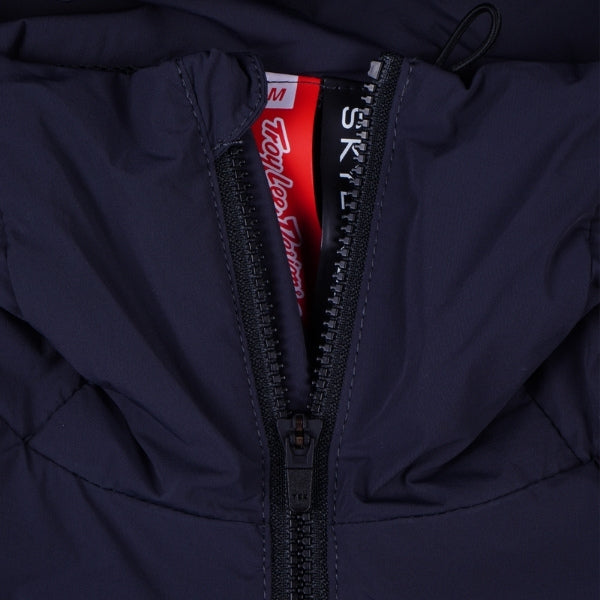 Troy Lee Designs Skyline Pro Mono mountain bike jacket in Carbon, close-up highlighting the chest area, visible zipper, branding, and fabric construction