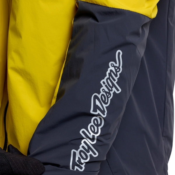 Troy Lee Designs Skyline Pro Mono mountain bike jacket in Acid, close-up highlighting a zipper, pocket construction, seams, and surrounding fabric