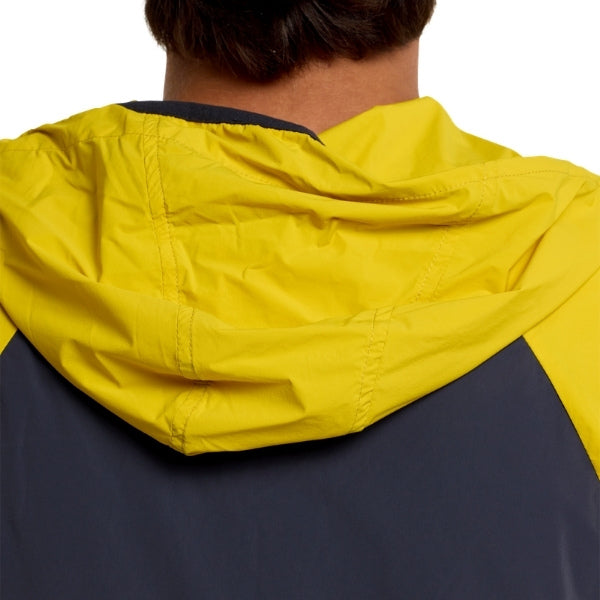 Troy Lee Designs Skyline Pro Mono mountain bike jacket in Acid, worn by a rider from the rear, showing the hood, back fit, and panel layout