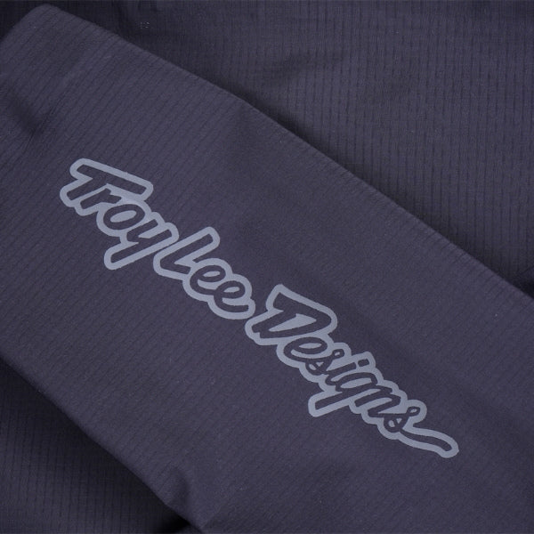 Troy Lee Designs Resist Pro Mono mountain bike jacket in Carbon, close-up highlighting the sleeve, side-panel construction, and Troy Lee Designs branding