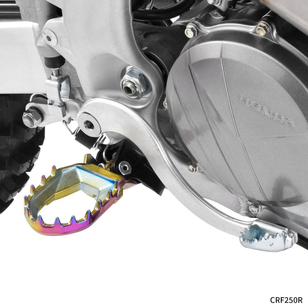 Professional studio photo of Zeta - Max Footpegs (Husqvarna); showing overall shape and visible design details; SKU 634-26; Colors: Black, Multicolor