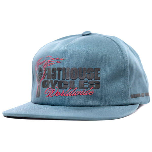 Fasthouse Spanner Hat SKU 3210050 – blue snapback motocross cap with flat bill, front logo reads “Fasthouse Cycles Worldwide” in bold black and red embroidery.
