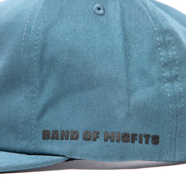 Fasthouse Spanner Hat SKU 3210050 – side panel close-up with “Band of Misfits” text in black, blue fabric construction.