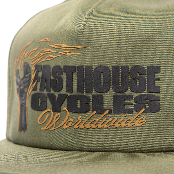 SKU 3210050 – Close-up of Fasthouse Spanner Hat front panel in olive green, highlighting raised “Fasthouse Cycles Worldwide” embroidery and flaming wrench logo, a staple accessory for motocross and off-road style.