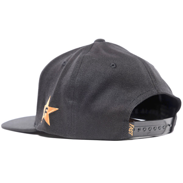 Rear three-quarter view of the black Fasthouse Crown hat (SKU: 3210150), showing the plastic snapback closure and a small Fasthouse tag. The embroidered star logo on the right side is visible.