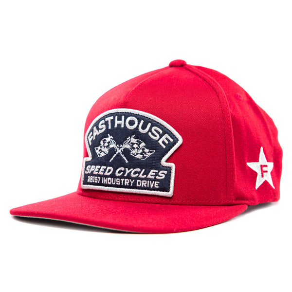 The Fasthouse Crown Hat (SKU 3210150) is a red, high-profile structured snapback with a flat brim. The front features a navy blue and white embroidered patch with the word