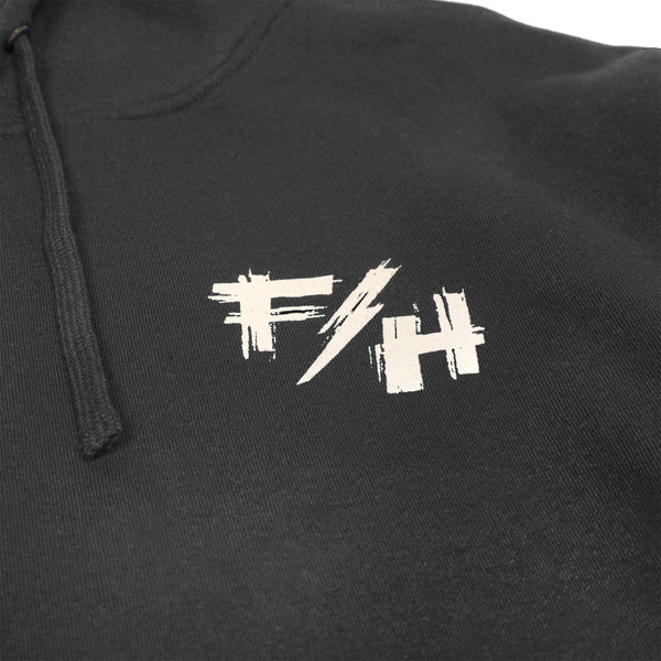 Close-up front chest detail of Fasthouse Fray Hoodie in black, SKU 32131805, with FH logo in distressed white print styled like motocross race graphics.