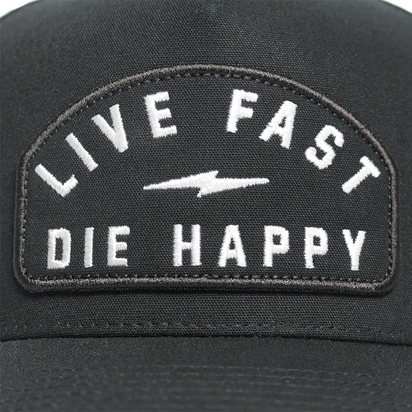 Close-up of Fasthouse WIRED Hat (SKU 3297960500) front panel patch with bold white text “Live Fast Die Happy” and lightning bolt detail, black snapback cap for motocross riders.