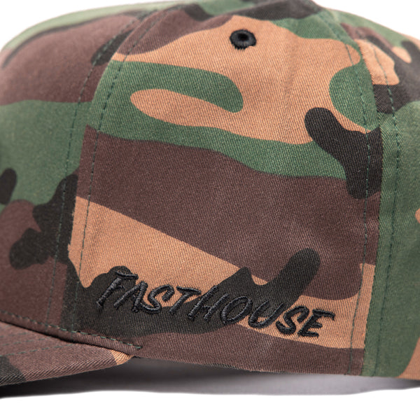 Side detail of Fasthouse Wired Hat SKU 3321098 in camouflage print, featuring tonal black embroidered Fasthouse logo on the panel, highlighting motocross heritage styling.