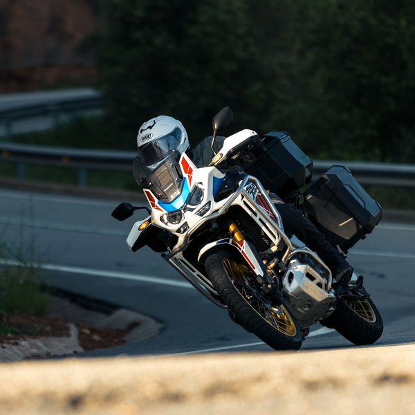 many riding a motorcycle wearing a white shoei helmet collection