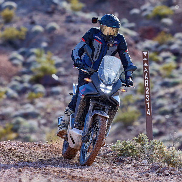man riding an adventure motorcycle wearing a black shoei helmet collection