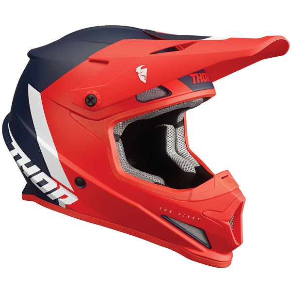 Studio view of Thor - Sector Chev Helmet helmet helmet, in Red and Navy, vented chin bar and intake ports, on a clean white background, (SKU 011073) Colors: Blue and Light Gray, Charcoal and Orange, Gray and Black, Red and Navy Sizes: 2XL, 3XL, 4XL, LG, MD, SM, XL, XS