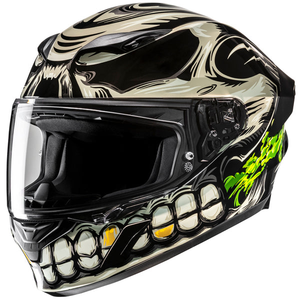 810400503 | A full-face motorcycle helmet with a skull design painted in black, white, and green colors, featuring detailed teeth and eye socket motifs, set against a plain white background. The helmet has a clear visor, black interior padding, and visible mechanical components on the side, with a sleek, glossy finish and a slightly aggressive, edgy aesthetic. | Available at BTO Sports