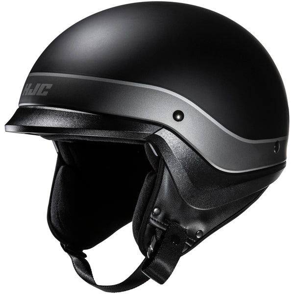 822150503 | A black motorcycle helmet with a matte finish, featuring a silver stripe running horizontally around the middle, with the brand logo 'HJC' on the side. The helmet has a smooth, rounded shape with a slightly extended visor area, and a black interior lining visible at the bottom. It is photographed against a plain white background with soft, even lighting that highlights its contours and texture. | Available at BTO Sports
