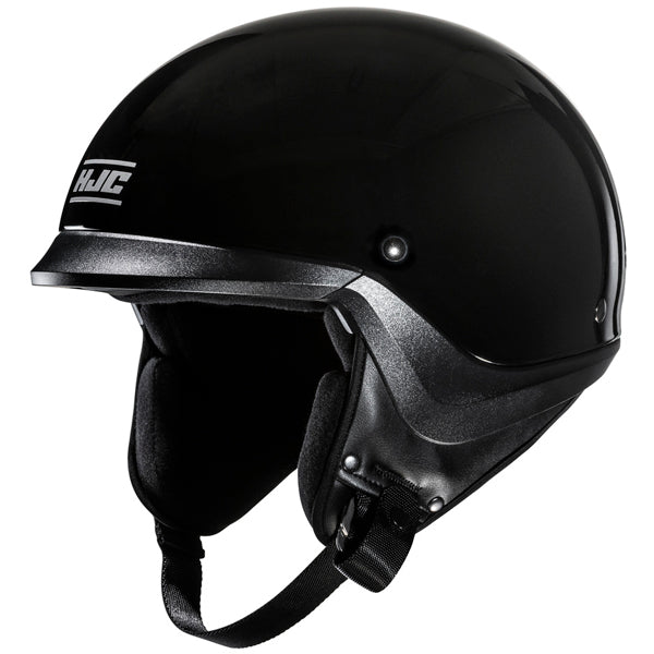822020503 | A sleek, black motorcycle helmet with a glossy finish, featuring a silver trim along the bottom edge and a small, round vent on the side. The helmet has a smooth, rounded shape with a slightly extended visor at the front, and the interior padding is visible around the open face area. The background is plain white, emphasizing the helmet's modern, minimalist design, with soft lighting creating subtle reflections on its surface. | Available at BTO Sports