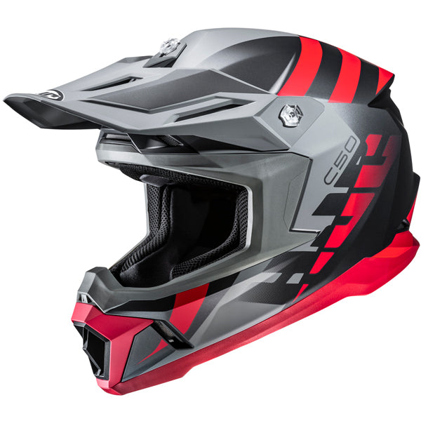 A full-face motocross helmet with a sleek, angular design featuring a matte gray finish accented by bold red and black graphics, including the number '50' on the side. The helmet has a prominent chin guard with a vent, a wide visor with a slight upward curve, and a black interior lining visible through the open face area. The background is plain white, emphasizing the helmet's modern, aggressive style with high contrast lighting that highlights its contours and textures.