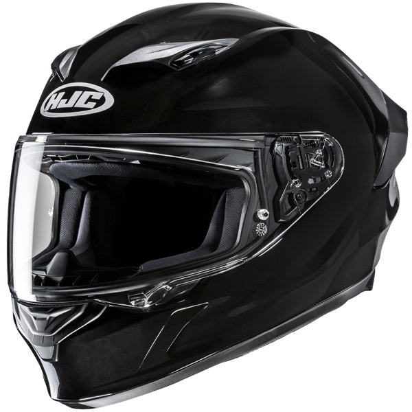 810017703 | A black full-face motorcycle helmet with a clear visor, featuring the HJC logo in white on the front top. The helmet has a sleek, aerodynamic design with subtle silver accents on the top and sides, and visible mechanical components near the visor hinge. It is set against a plain white background, with soft, even lighting highlighting its glossy finish and contours. | Available at BTO Sports