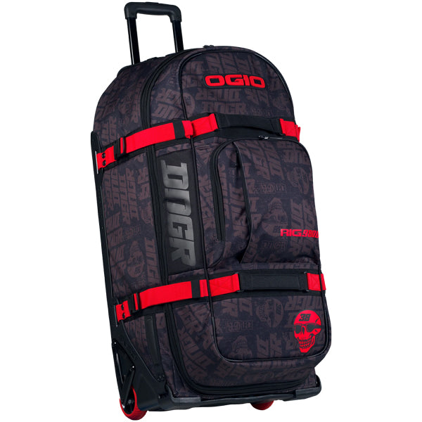 Front three-quarter view of OGIO RIG 9800 DNGR X rolling gear bag in black with allover DNGR graphic, red compression straps, extended telescoping handle, and red wheels, SKU 80100025 | Available at BTO Sports