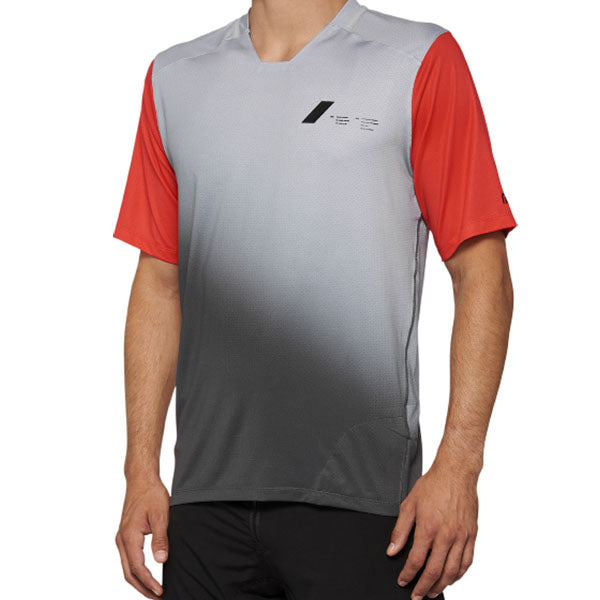 Detailed studio photograph of 100%, Celium Jersey (MTB), SKU 50200095, color Gray/Racer Red, sizes SM, MD, LG, XL, Designed for Mountain Bike, BMX and E-Bike riders