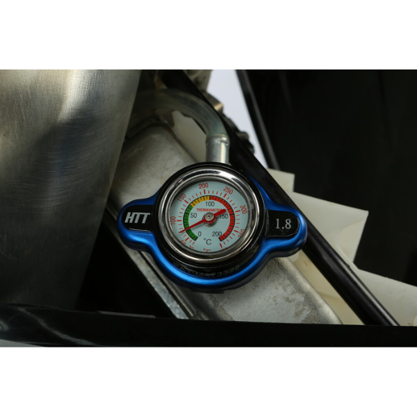 Studio product photo on a white background of Fire Power, Radiator Caps with Temperature Gauge, showing product profile and surface details, Colors: Most Japanese Models, Blue, 26psi (1.8KG), Most KTM/Husqvarna up to 2015, Blue, 26psi (1.8KG), Most KTM/Husqvarna '16+, Black, 28.5psi (2.0KG), SKU 57-145
