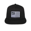 Front view of Alpinestars Flag Flat Trucker Hat SKU 48276370 in black, structured fit with mesh back and bold white Alpinestars flag patch, motocross streetwear hat.