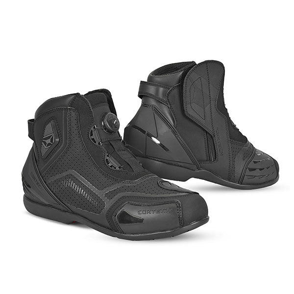 A pair of Cortech Sport Lite Boots for motorcycle riding, featuring a black perforated upper with TPU shins and a no-lacing fit system.