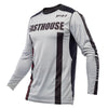 Image of Fasthouse Elrod Storm Jersey (SKU: 3931307504) in Fog/Black colorway, displayed flat with front view showing athletic fit, V-shaped ribbed collar, and sublimated artwork. Designed for motocross, dirt bike, ATV, and UTV riders with breathable mesh panels and moisture-wicking fabric.