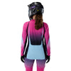 Fox Racing Flexair SE TS57 Long Sleeve Jersey (MTB) (Womens) in Pink, full modeled front view, with the crew neck, long sleeves, contrasting shoulder and arm graphics, and extended rear hem on a rider. Available options—Color: Pink; Size: XS, SM, MD, LG, XL.